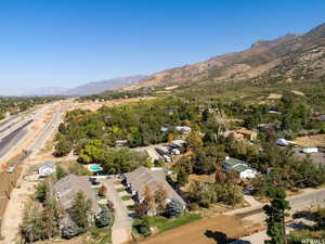Aerial view of property and surrounding area featuring mountains