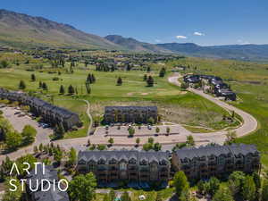 Aerial view of a mountainous background and a local golf course