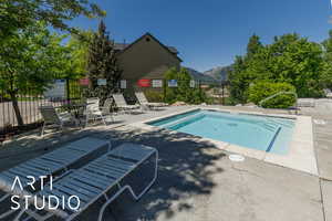 View of main Jacuzzi with a mountain view, a patio area,