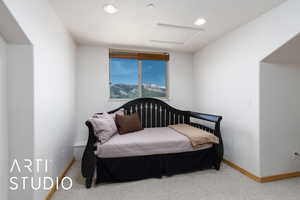 Carpeted bedroom featuring attic access, baseboards, and recessed lighting