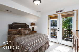 Bedroom with carpet floors and access to outside