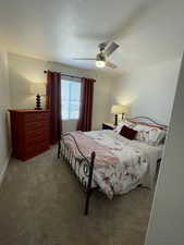 Bedroom featuring ceiling fan and carpet flooring