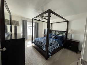 Carpeted bedroom with ceiling fan