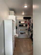 Walk in closet featuring carpet floors