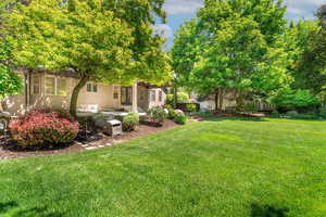 View of yard featuring a covered patio and spa