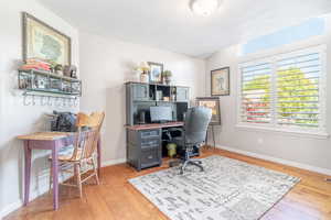 Office area with hardwood floors and lots of natural light.