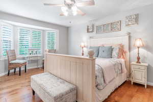 Primary bedroom with hardwood floors, bay window and vaulted ceiling