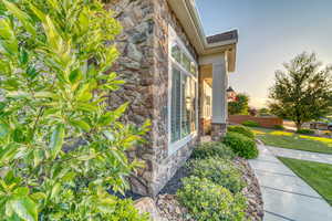 View of side of home featuring stone siding