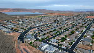 Aerial overview of property's location featuring mountains and nearby suburban area