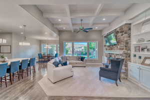 Living room with ceiling fan, recessed lighting, beam ceiling, healthy amount of natural light, and light wood-style flooring