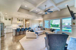 Living area with coffered ceiling, recessed lighting, a ceiling fan, beam ceiling, and light wood-style flooring