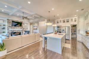 Kitchen featuring appliances with stainless steel finishes, recessed lighting, hardwood / wood-style floors, a fireplace, and a ceiling fan