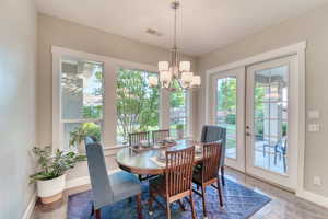 Dining space featuring a chandelier, baseboards, and wood finished floors