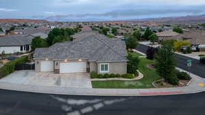 View of front of home with stucco siding, an attached garage, and a residential view