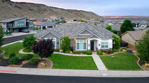 View of front of house with stone siding, a residential view, a mountain view, and a tiled roof