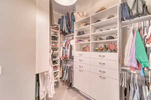 Walk in closet featuring light carpet