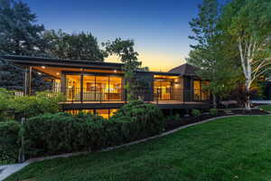 Rear view of property with a yard and a deck