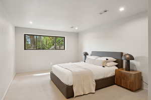 Bedroom featuring recessed lighting, baseboards, and light carpet