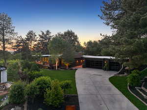 View of front facade with a front lawn, driveway, and an attached garage