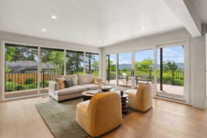 Living area with hardwood / wood-style floors and recessed lighting