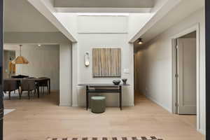 Hallway with wood finished floors and baseboards