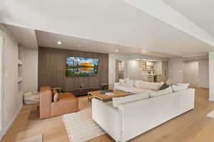 Living area with light wood-style flooring, recessed lighting, baseboards, and built in features