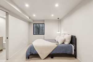Bedroom featuring recessed lighting, light carpet, and baseboards