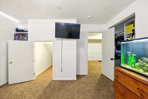 Carpeted bedroom featuring baseboards