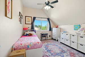 Bedroom featuring vaulted ceiling, a ceiling fan, and baseboards