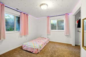 Carpeted bedroom with baseboards