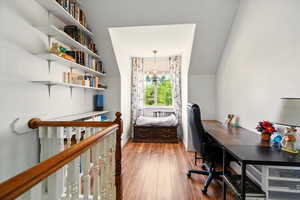 Office area featuring a chandelier, wood finished floors, and baseboards