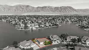 Aerial perspective of suburban area featuring a water and mountain view and property boundaries highlighted