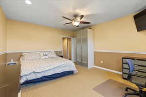 Carpeted bedroom featuring a desk, baseboards, ceiling fan, a closet, and recessed lighting
