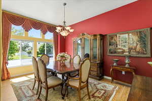 Dining room featuring a chandelier, wood finished floors, and baseboards
