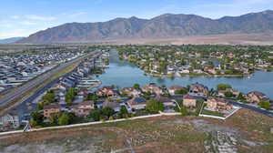 View of property location with a water and mountain view and nearby suburban area