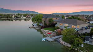 Aerial view at dusk of a water and mountain view and a residential view