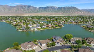 Aerial overview of property's location with nearby suburban area and a water and mountain view