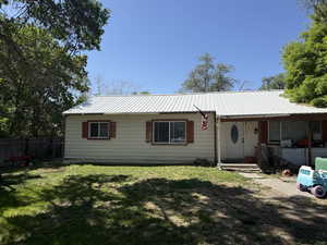 Ranch-style house with metal roof