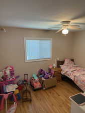 Bedroom with light wood finished floors and ceiling fan
