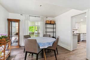 Dining room featuring light wood-style floors, and tall colonial baseboards