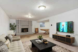 Staged den with light carpet, a textured ceiling, crown molding, and a fireplace