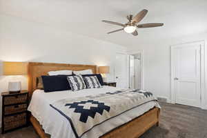 Spacious primary bedroom with carpet, colonial baseboards, and ceiling fan