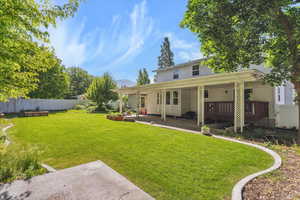 Rear view of property featuring a patio and back yard