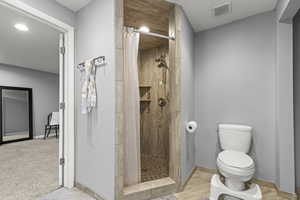 Bathroom featuring vanity, walk-in shower, and heated flooring.