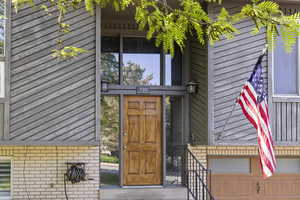 Split entry with 2 car garage, wood siding and landscaping
