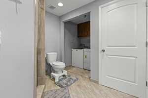 Bathroom featuring vanity, walk-in shower, and heated flooring.