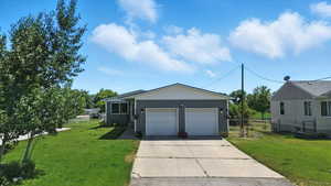 View of front of home featuring driveway and a garage