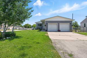 Ranch-style home with driveway and an attached garage