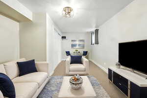 Virtually Staged Photo: Carpeted living room with baseboards