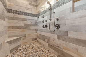 Massive walkin shower with his/hers shower heads and controls.